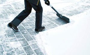 Technician Removing Snow from sidewalk